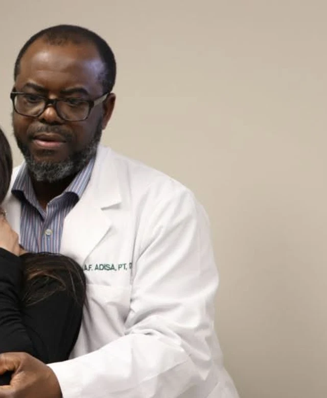 Dr. Abdul-Fatai B. Adisa, founder of RCA Physical Therapy, working with a patient