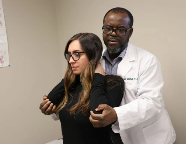 Dr. Abdul-Fatai Adisa performing hands-on manual therapy on a patient at RCA Physical Therapy